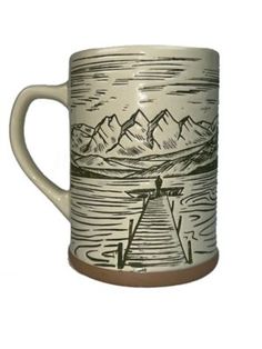 a coffee mug with mountains on it