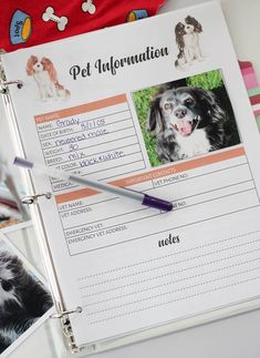 a pet information book with pictures of dogs and their names on the page, next to a pen