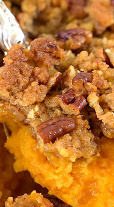 a close up view of some food on a plate with pecans and other toppings