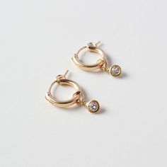 Super cute everyday huggie earrings, perfect for wearing alone or layering!Made from 14K Gold Filled and Clear CZSold as a set of 2Stones are 4mm, hoops are 13mm diameter. Gold Filled has 100 times more gold than gold plated jewelry. Gold filled wire is created by taking a sheet of 14 karat gold and bonding it through extreme heat and pressure to a core of semi-precious metal (brass). This is a very sophisticated process and only a few mills in the world do it. You should not mistake this proces Everyday Huggie Earrings With Dangling Charms, Yellow Gold Huggie Earrings With Dangling Charms For Everyday, 14k Gold Dangle Huggie Earrings For Everyday, Everyday 14k Gold Dangle Huggie Earrings, Everyday Yellow Gold Huggie Earrings With Dangling Charms, Huggie Earrings With Dangling Charms, Dainty Round Hoop Earrings With Dangling Charms, 14k Gold Filled Huggie Earrings With Dangling Charms, 14k Gold-filled Huggie Earrings With Dangling Charms