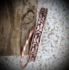 copper band with hand engraved scrollwork. Pair it with a twisted copper bracelet for a unique look. (twisted bracelet not included) 6" long 3/8" wide Adjustable Engraved Bronze Bracelets, Copper Bracelet Rustica Jewelry, Symbolic Engraved Copper Jewelry, Copper Etched Bracelets As A Gift, Adjustable Etched Copper Jewelry, Engraved Gold Copper Bracelets, Gold Engraved Copper Bracelet, Engraved Copper Bracelet Jewelry, Engraved Bronze Copper Bracelets