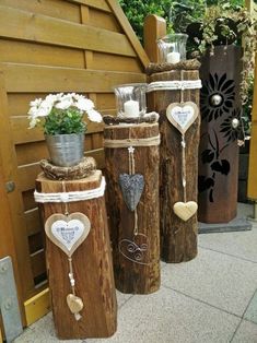 three wooden poles with hearts and flowers on them