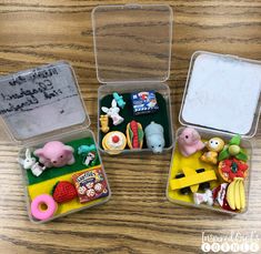 three small plastic containers filled with food on top of a wooden table