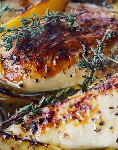 chicken with herbs and lemons in a skillet