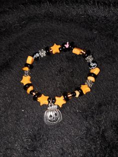 Halloween bracelet handmade with pumpkin charm and various black and orange beads. Bracelet is supported by a colored cord. Handmade with love and care in North Carolina, United States!! Halloween Black Charm Bracelet, Casual Black Bracelets For Halloween, Handmade Casual Halloween Jewelry, Casual Handmade Halloween Jewelry, Casual Handmade Jewelry For Halloween, Orange Beaded Bracelets For Halloween Gift, Orange Beaded Bracelets For Halloween, Handmade Orange Bracelets For Halloween, Gothic Bracelet