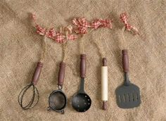 five kitchen utensils are lined up on a burlap background with the words country craft house written across them