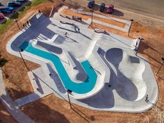 an aerial view of a skateboard park with ramps, ramps and water features in the pool