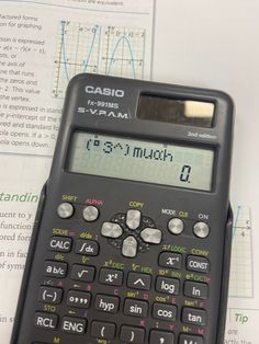 a calculator sitting on top of an open book