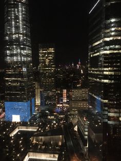 the city skyline is lit up at night