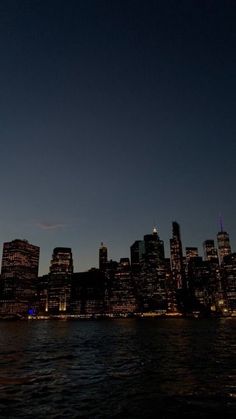 the city skyline is lit up at night