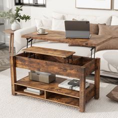 a living room with a couch, coffee table and laptop on top of the table