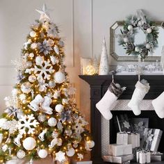 a decorated christmas tree next to a fireplace