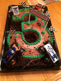 a cake shaped like a number with cars on it