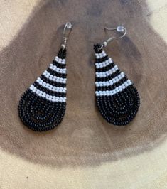 These handmade beaded earrings are truly unique. Each one is hand made with a rotating pattern. These earrings are available in a multitude of colors -making them perfect for any outfit! Whether it's dressing up a jean jacket or adding a unique texture to a LBD, there's no way you can go wrong with these earrings! We have given each design a name in honor of our favorite people! Black Beads Teardrop Earrings, Adjustable Teardrop Beaded Earrings With Black Beads, Artisan Black Beaded Earrings With Ear Wire, Casual Handmade Beaded Dangle Earrings, Handmade Casual Beaded Earrings, Casual Handmade Beaded Earrings, Trendy Handmade Black Beaded Earrings, Trendy Handmade Teardrop Beaded Earrings, Handmade Black Casual Earrings