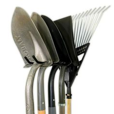 a set of four metal spatulas sitting on top of each other