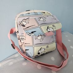 Add a touch of whimsical charm to your wardrobe with our Snoopy Crossbody Bag! Featuring beloved characters from the Peanuts gang in delightful pastel colours, this bag is both stylish and functional. Design: This adorable crossbody bag showcases playful cartoon drawings of Snoopy, Charlie Brown, and friends, all in soft, pastel hues that exude a cheerful vibe. Strap: The bag comes with a sturdy yet fashionable pink strap, perfect for slinging over your shoulder for a comfortable, hands-free exp Kawaii Crossbody Satchel For Travel, Charlie Brown And Friends, Brown And Friends, Snoopy Backpack, Snoopy Purse, Kawaii Crossbody Shoulder Bag, Sanrio Crossbody Bag, The Peanuts, Pastel Colours