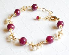 Luscious red rubies are featured in this artisan style jewelry. Accented with beautiful white freshwater pearls. Set in 14k gold filled findings. Give a gift that she will treasure for a lifetime. Exquisite ruby bracelet is perfect for women who love artisan jewelry, love red gemstones, and for women born in July since ruby is her birthstone.Bracelet Details:- Bracelet Length is adjustable from 7 to 8 inches (17.78 cm to 20.32 cm)- Handmade with 14k gold filled wire, chain and lobster clasp with Ruby And Pearl, Pearl Bracelet Gold, Bridal Party Jewelry, Ruby Bracelet, Carnelian Jewelry, July Birthstone Jewelry, Red Jewelry, Wedding Jewelry Bracelets, Red Gemstones