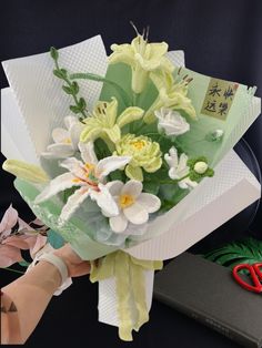 a bouquet of flowers is being held by someone