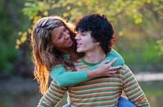 a young man and woman embracing each other