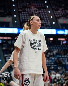 a female basketball player is standing on the court