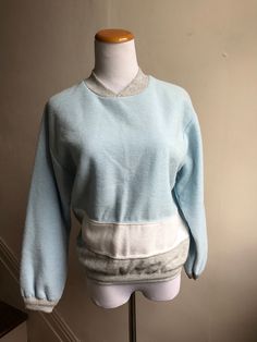 Vintage items make great unique and unexpected gifts. Vintage 80s Sweatshirt | Richard Simmons Workout Top | Retro Baby Blue Sweatshirt | Throwback Willy-Dee Colorblock 80s Gym Top | Campus Top CONDITION: Vintage Excellent MEASUREMENTS: 21" sleeve 19" shoulder to shoulder 22.5" long 39" chest 28" across bottom  LABEL SIZE: M BRAND: Willy-Dee // Made in the USA  FEATURES: Totally retro sweat top with colorblock concept baby blue, gray and white; high v-neck.  Shop VintageBobbieMaude for MORE: https://www.etsy.com/shop/VintageBobbieMaude Retro Crew Neck Sweatshirt For Loungewear, Vintage Oversized Tops With Ribbed Cuffs, Oversized Vintage Tops With Ribbed Cuffs, Vintage Crew Neck Tops For Loungewear, Retro Winter Loungewear Tops, Vintage Crew Neck Sweatshirt For Loungewear, Vintage Cotton Sweater For Loungewear, Retro Blue Tops For Loungewear, 80s Gym