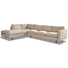 a beige sectional couch sitting on top of a white floor