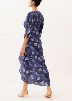 The Katherine is a floor-length dress that sports an empire waistline, a V-neck with hook and eye closure, half-length kimono sleeves, and a wrap skirt. Its distinctive pattern is designed in-house and printed on 100% viscose fabric. Its airy construction makes it an ideal choice for weddings, cocktail parties, and other informal occasions. Jaline is made by women in NYC. The Katherine dress is one of our bestsellers as it fits all body shapes due to its empire-style waistline. As we cut to orde Blue Beachwear Maxi Dress With Kimono Sleeves, Blue Printed Dresses With Surplice Neckline, Blue Open Front Beach Dress, Flowy Wrap Midi Dress For Beach, Blue Maxi Dress With Kimono Sleeves For Beach, Blue Maxi Wrap Dress For Vacation, Blue Maxi Length Wrap Dress For Vacation, Blue Wrap Dress With Surplice Neckline For Beach, Blue Surplice Neckline Dress For Beach