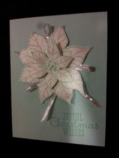 a christmas card with a pink poinsetti on it