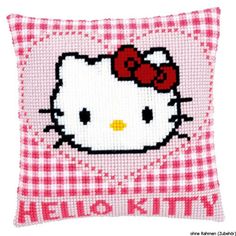 a hello kitty pillow with a red bow on it's head and the words hello kitty