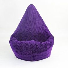 a purple bean bag sitting on top of a white floor