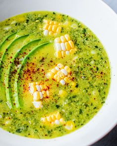 a white bowl filled with corn and broccoli soup