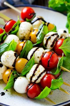 a white plate topped with skewers filled with veggies