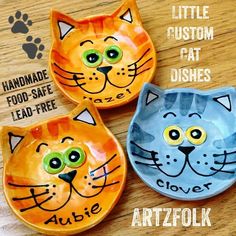 three handmade cat dishes on a wooden table with the words artzfolk above them