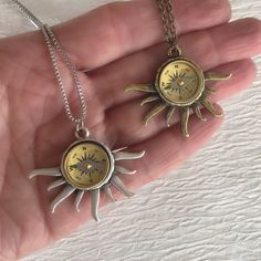 Please note: If you need more than one, multiple quantities are available upon checkout. A real working compass is set into a beautiful sun ray bezel to create a unique necklace. A beautiful gift for an avid hiker or traveler. The sun pendant is about 35mm long and 42mm wide. It is available in antique silver tone and antique gold tone. The pendants are plated brass. The compass is brass with a glass face. It measures 16mm in diameter. The compass is delicate and should be handled with care. Due Outdoor Medallion Necklace With Compass Design, Outdoor Compass Design Round Pendant Jewelry, Outdoor Compass Design Round Jewelry, Compass Jewelry, Sun Charm, Sun Necklace, The Compass, Sun Pendant, Compass Necklace