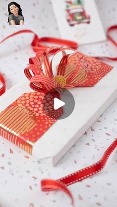 an open gift box with red ribbon on it