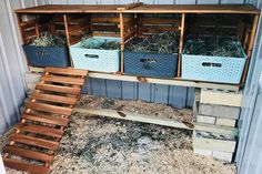 an outdoor storage area with crates and baskets on the shelves, next to a set of stairs