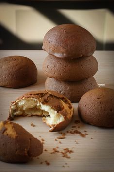 several chocolate cookies are stacked on top of each other and one is broken in half