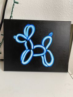 a black box with a blue dog on it sitting on top of a white table