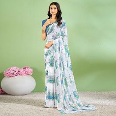 Blue colored saree is made from chiffon fabric which is highlighted with beautiful floral printed work as shown. Comes along with unstitched chiffon blouse piece which you can customise as per your design/style. Occasion - You can wear this saree for casual and daily wear. Note:- the actual product may differ slightly in color and design from the one illustrated in the images when compared with computer or mobile screen. Measurements: Saree : Chiffon : 5.5 Mtrs Blouse : Chiffon : 0.8 Mtr Material: Chiffon Stitch Type: Unstitched Country of Origin: India Care Guide: Dry Clean Georgette Pre-draped Saree With Floral Print, Navratri Floral Print Georgette Pre-draped Saree, Blue Floral Print Georgette Blouse Piece, Blue Floral Print Blouse Piece In Georgette, Blue Georgette Dupatta With Digital Print, Bollywood Chiffon Dupatta With Printed Border, Bollywood Style Chiffon Dupatta With Printed Border, Unstitched Chiffon Saree With Printed Border, Blue Floral Print Pre-draped Georgette Saree