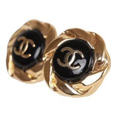 These 22A Chanel stud earrings are in the signature CC logo with a sunburst design, and are gold tone with a black enamel contrast background. Origin: France Condition: New and never worn Accompanied by: Chanel box and pouch Measurements: 1" x 0.6" Designer Black Clip-on Earrings, Luxury Black Round Clip-on Earrings, Designer Black Round Earrings, Luxury Metal Clip-on Earrings, Designer Black Clip-on Jewelry, Classic Formal Enamel Earrings, Classic Enamel Earrings For Formal Occasions, Luxury Black Earrings With Polished Finish, Designer Black Metal Jewelry