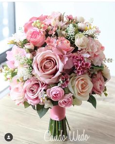 a bouquet of pink and white flowers on a table