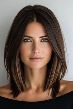 Woman with shoulder-length brown hair and a serious expression in a black off-shoulder top, against a plain background. Med Length Hairstyle Women Straight, Hairstyle Frame Face, Short Hair With Straight Hair, Straight Dark Hairstyles, At Shoulder Haircut, Short Or Medium Haircuts, Wedding Guest Hairstyles Medium Straight, Trendy Haircuts For Shoulder Length Hair, Winter Shoulder Length Hair