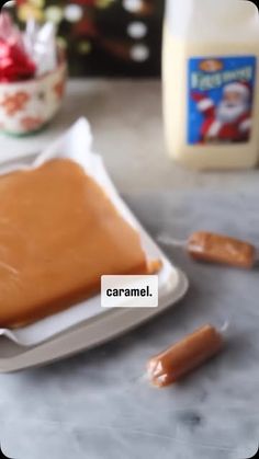 there is a small white plate with caramel on it