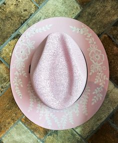 Turn heads with this beautiful one-of-kind baby pink fedora. This cute and feminine design will add a soft yet unique touch to anyone who wears her! The unique design is handpainted by me. There are Swarovski crystal permanently adhered and almost impossible to remove, I've tried! The paint is sealed so cleaning it will not remove the paint!  My mission is to bring the joy of living in the moment by creating beautiful pieces that bring a relaxed and festive vibe to every day! This hat is handmade in Mexico and hand painted by me Enjoy this water resistant fashion statement by the pool, or grilling outside. This jute hat is breathable, and fits comfortably as it protects you from the harsh sun. The hat is about 23 inches in circumference & right now sizers are included at no additional cost Cheap Pink Hat Bands For Rodeo, Cheap Pink Acrylic Hats, Pink Western Straw Hat For Summer, Pink Bohemian Sun Hat For Kentucky Derby, Bohemian Pink Sun Hat For Kentucky Derby, Pink Adjustable Hat Bands For Summer, Bohemian Pink Hat Band For Kentucky Derby, Bohemian Pink Hat Band For Beach, Pink Straw Hat For Rodeo, Summer