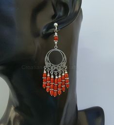 "♥ Meticulously handcrafted earrings made from precious Mediterranean coral. The coral is unique, all natural and hasn't been treated or dyed in any way. Earrings are based on a silver wire, around filigree centerpiece. Design of the filigree pattern, is inspired by traditional, Croatian filigree jewelry. Everything is handmade from solid sterling silver 925. ♥ Total dimensions: ~ 6.9 x 2 cm ( 2.71 x 0.79\" ) - - - - - - - - - - - - - - - - - - - - - - - - - - - Fast & Favorable 🛩️ DHL WORL Handmade Coral Earrings In Red Coral, Handmade Red Coral Dangle Earrings, Hand-strung Red Coral Jewelry, Artisan Red Coral Hand-strung Jewelry, Red Coral Earrings, Silver Chandelier, Filigree Pattern, Filigree Jewelry, Jewellery Marketing