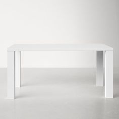 a white table sitting on top of a cement floor