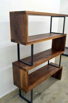 a wooden shelf with metal legs and shelves on each side, against a white wall