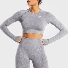 Gymshark Vital Seamless Long Sleeve Crop Top Smokey Grey Marl Extra Small Xs Nwt - Midriff Crop - Raglan Sleeves Detailed With Figure-Contouring Shades - Sweat-Wicking Fabric - Thumb Holes - 59% Nylon, 34% Polyester, 7% Elastane - Label Colour: Smokey Grey Marl Womens Exercise Routine, Seamless Crop Top, Long Sleeve Activewear, Womens Clothing Patterns, Gymshark Women, Performance Wear, Christmas 2020, Active Wear Outfits