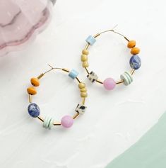 ---------------- PLEASE READ DESCRIPTION BEFORE ORDERING ------------- Set of bright and colorful beaded hoop earrings DETAILS: 40mm hoops Gold filled hoops Earring post are lead and nickel free. PROCESSING TIME: Our items are made to order. Processing times may vary due to holidays or demand. The processing time for this item is 1-3 business days before it ships. In order to ship each order on time, we are not able to bypass the processing times on any of our items. If you are under time restra Colorful Bohemian Hoop Jewelry, Multicolor Beaded Hoop Jewelry, Multicolor Hoop Earrings With Large Beads As Gift, Colorful Beaded Round Hoop Earrings, Multicolor Small Hoop Jewelry With Spacer Beads, Colorful Small Hoop Jewelry With Colorful Beads, Multicolor Hoop Jewelry For Jewelry Making, Colorful Small Hoop Beaded Jewelry, Multicolor Hoop Beaded Earrings With Spacer Beads