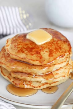 a stack of pancakes with butter on top and syrup drizzled over them